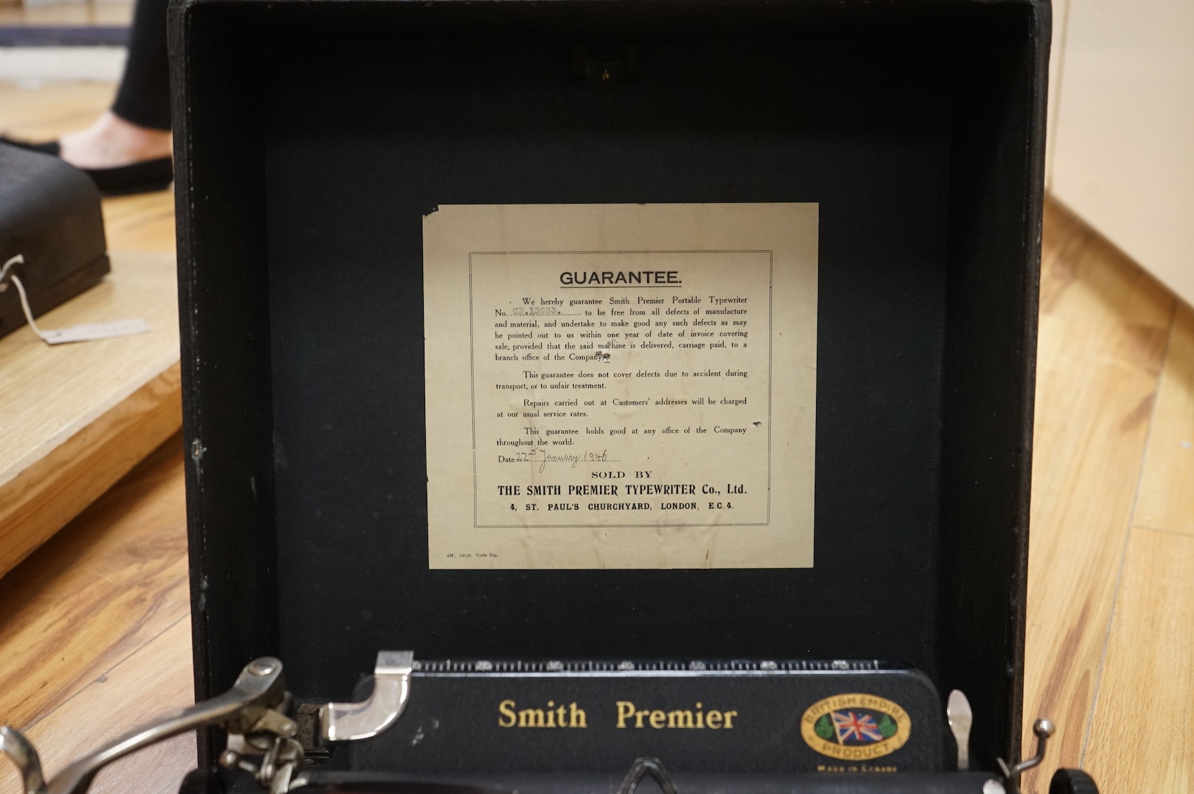 A cased portable Smith Premier Model 5 typewriter, with original guarantee sales label to the inside of the lid dated 22 January 1946.